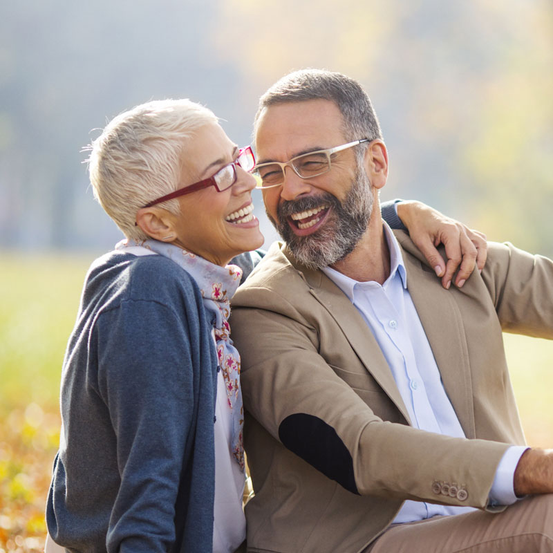 two people smiling outside
